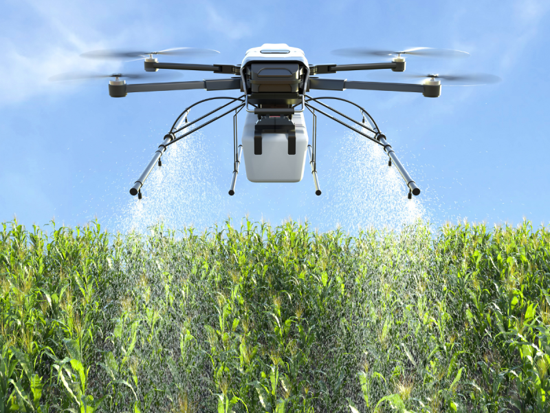 “Drone irrigating a crop field, showcasing modern agricultural technology and precision farming in agriculture