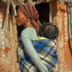 a woman carrying a child