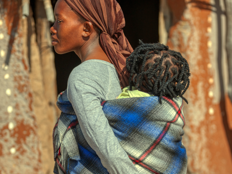 a woman carrying a child